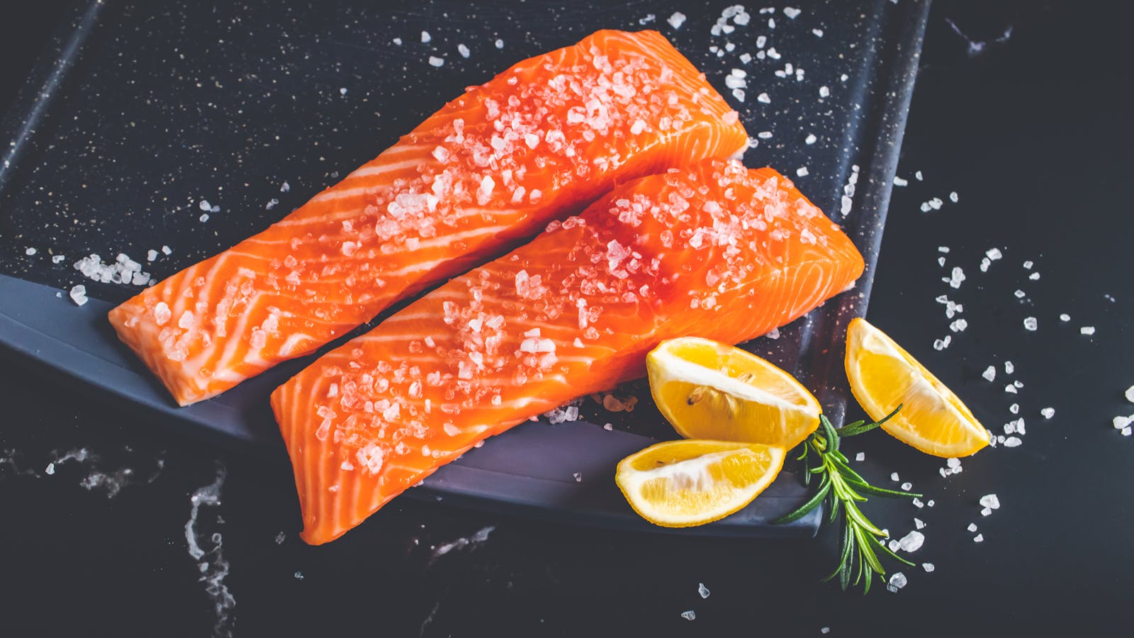 Fresh salmon fillet with lemon and herbs — a source of omega-3